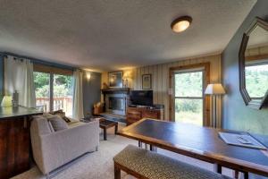 a living room with a couch and a table at Slope-Side Getaway Deck Pool Table Views in Boise