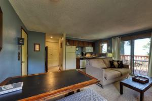 a living room with a couch and a table at Slope-Side Getaway Deck Pool Table Views in Boise