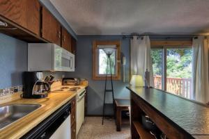 a kitchen with a sink and a counter top at Slope-Side Getaway Deck Pool Table Views in Boise +17 photos