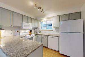 a kitchen with white appliances and a white refrigerator at Private Townhome - Mountain Views & 2 Baths in Boise