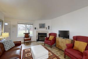 a living room with a couch and chairs and a tv at Private Townhome - Mountain Views & 2 Baths in Boise