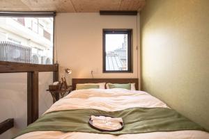 a bedroom with a bed with a purse on it at Nijojo Taiken Inn in Kyoto +54 photos