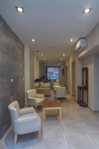 a living room with couches and chairs and a table at Apart Hotel Veladero in San Juan