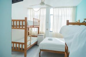 a bedroom with two bunk beds and a bed at Bungalows Spilberg in Colán +22 photos