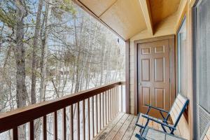 a blue chair sitting on a porch with a window at McCall Mountain Condo Pool Sauna Deck in McCall