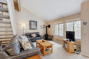 a living room with a couch and a tv at McCall Mountain Condo Pool Sauna Deck in McCall