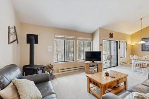 a living room with a couch and a wood stove at McCall Mountain Condo Pool Sauna Deck in McCall