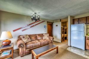 a living room with a couch and a refrigerator at Mountain Retreat Slope Access 2 Decks in Boise