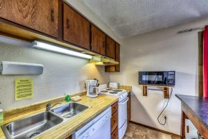 a small kitchen with a sink and a microwave at Mountain Retreat Slope Access 2 Decks in Boise