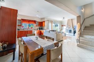 a kitchen and dining room with a table and chairs at Filerimos Dream Villa in Ialysos