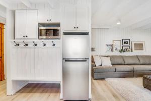 a white kitchen with a refrigerator and a couch at Ski-In Ski-Out Studio at Bogus Basin in Boise +28 photos