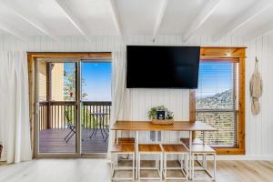 a living room with a flat screen tv on the wall at Ski-In Ski-Out Studio at Bogus Basin in Boise