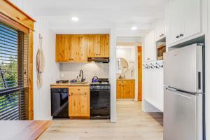 a kitchen with wooden cabinets and a white refrigerator at Ski-In Ski-Out Studio at Bogus Basin in Boise