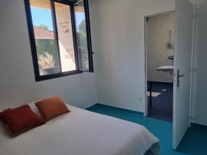 a bedroom with a bed and a window and a sink at L'éveil à la nature in Limoges