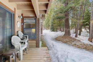 a porch with chairs and a table on a house at Golf Course Retreat - Pool Access Lake Views in McCall +22 photos