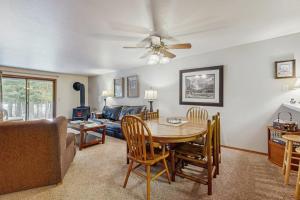 a living room with a table and a couch at Golf Course Retreat - Pool Access Lake Views in McCall