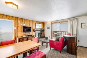 a living room with a table and red chairs at Mountain Condo Ski Access & Sunset Deck in Boise +20 photos
