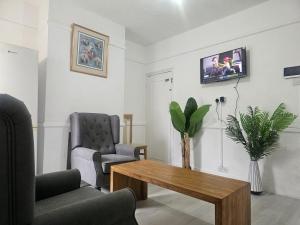 a living room with two chairs and a coffee table at Seraphic Homes Medway Kent in Gillingham