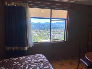 a bedroom with a large window with a view at Casa Amelia Hotel & Boutique in Zacatlán +29 photos