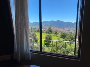 a window with a view of a city at Casa Amelia Hotel & Boutique in Zacatlán