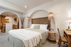 a bedroom with a large bed and a kitchen at Chic Elysium in Naxos Chora
