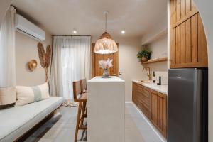 a kitchen with a couch and a refrigerator in a room at Chic Elysium in Naxos Chora