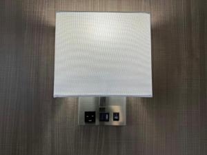 a lamp with a white shade on a wall at Red Roof Inn Reno in Reno