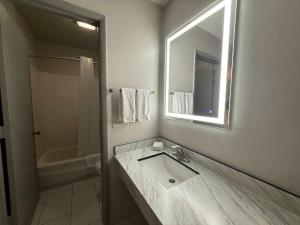 a bathroom with a sink and a mirror at Red Roof Inn Reno in Reno