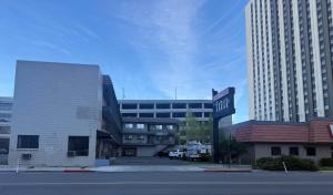 a street sign in front of a building with tall buildings at Red Roof Inn Reno in Reno +18 photos