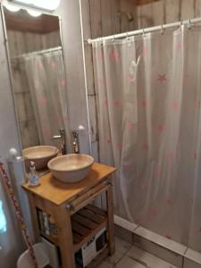 a bathroom with two sinks and a shower at El Druida 3 in Villa General Belgrano +9 photos