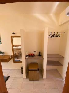 a room with stairs with a shelf and a mirror at Tree House Hotel Dahab in Dahab +77 photos