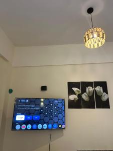 a room with two pictures of flowers on the wall at Tree House Hotel Dahab in Dahab