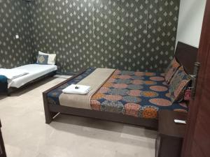 a bedroom with two beds in a room at The Velmora G-13 in Islamabad