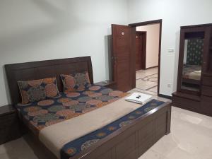 a bedroom with a bed and a mirror in it at The Velmora G-13 in Islamabad