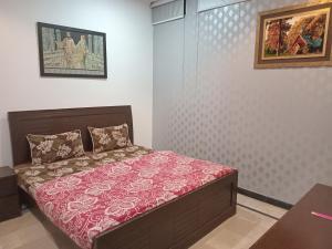 a small bedroom with a bed in a room at The Velmora G-13 in Islamabad