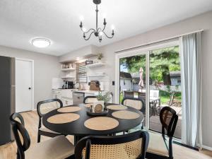 a dining room and kitchen with a table and chairs at Beautiful Ranch with Outdoor Patio and Room for 6 in Munroe Falls