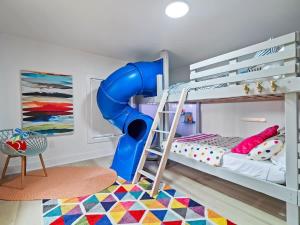 a bunk bed with a slide in a room at PoolTable - Hot Tub - FirePit - Games - Bunk Slide - Wet Bar in Akron
