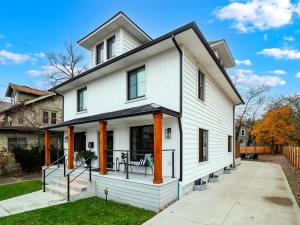 a white house with orange columns at PoolTable - Hot Tub - FirePit - Games - Bunk Slide - Wet Bar in Akron