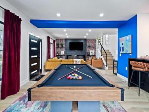 a living room with a pool table at PoolTable - Hot Tub - FirePit - Games - Bunk Slide - Wet Bar in Akron
