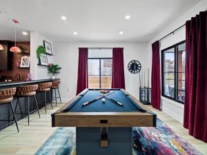 a pool table in a room with a bar at PoolTable - Hot Tub - FirePit - Games - Bunk Slide - Wet Bar in Akron +60 photos