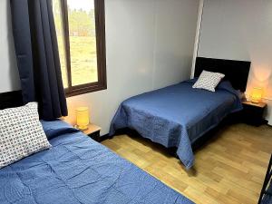 a bedroom with two beds and a window at Casa Bonassola, Barra de Navidad in Barra de Navidad