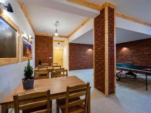 a dining room with a ping pong table and a ping pong table at Golden Apartments - Villa Taternik - Tatry View in Zakopane