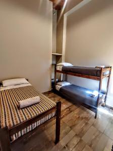 a room with two bunk beds in a room at El Aromo Cafayate in Cafayate