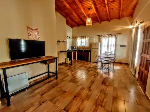 a living room with a large flat screen tv at El Aromo Cafayate in Cafayate