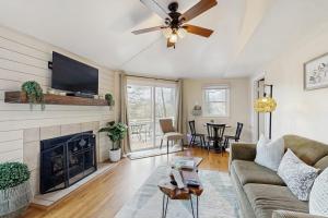 a living room with a couch and a fireplace at The Treehouse at Banner Elk in Banner Elk
