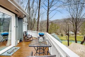 a balcony with a table and chairs on a house at The Treehouse at Banner Elk in Banner Elk