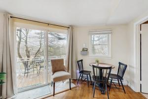 a dining room with a table and chairs and a window at The Treehouse at Banner Elk in Banner Elk