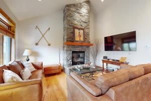 a living room with two couches and a fireplace at Big Sky Bliss in Big Sky