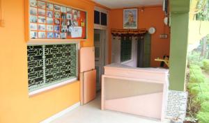 a restaurant with orange walls and a door with a window at Hotel Anjali Lodge Malvan in Malvan