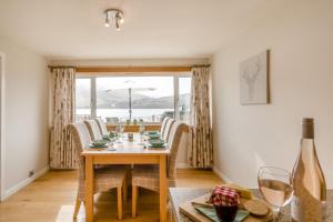 a dining room with a table and chairs and a window at 3 Bed in Lochearnhead oc-c33641 in Lochearnhead +22 photos